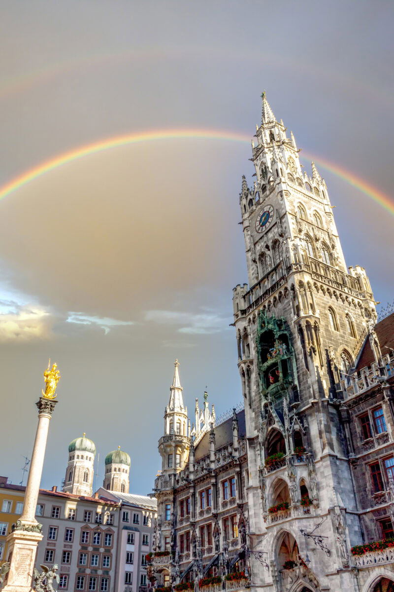 View of Munich’s New Town Hall at Marienplatz with a rainbow in the sky – key visual for the upcoming Staytoo student apartments in Munich