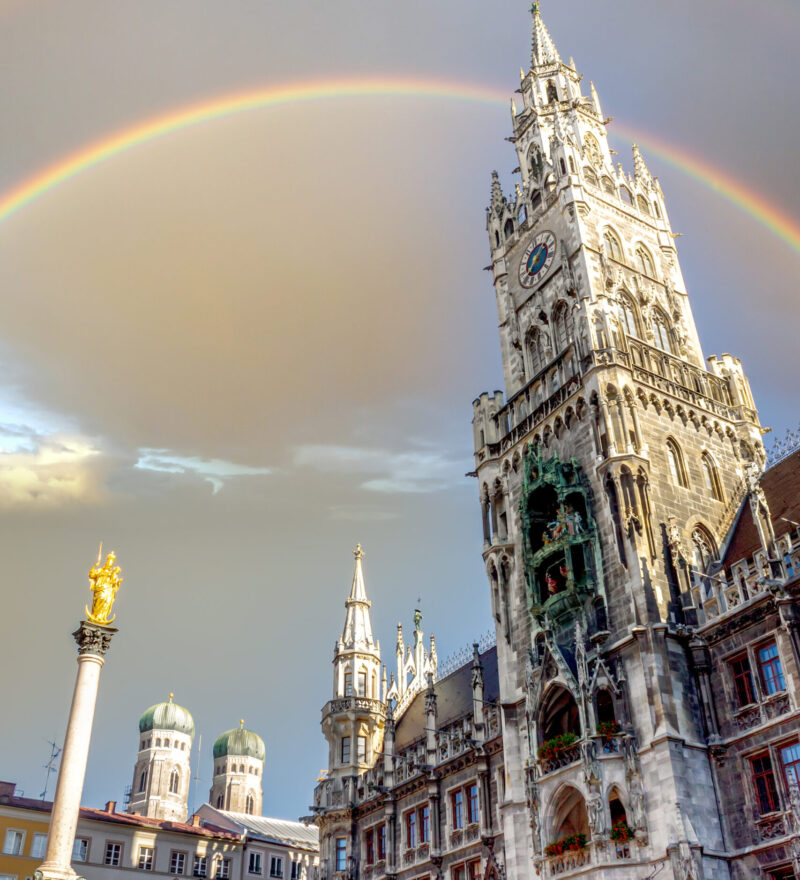 View of Munich’s New Town Hall at Marienplatz with a rainbow in the sky – key visual for the upcoming Staytoo student apartments in Munich