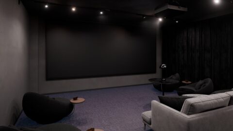 Cinema room at the munich student apartments Staytoo Munich South with large screen and lounge seating