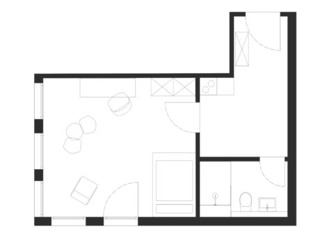 Grundriss eines möblierten Einzimmerapartments mit großzügigem Wohn- und Essbereich, separater Küche, Badezimmer und Eingangsbereich.